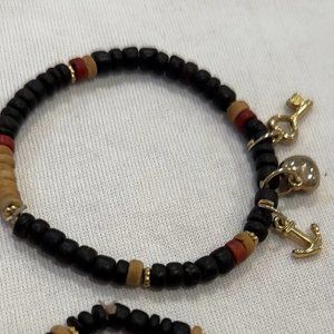2 Black bracelets with gold charms